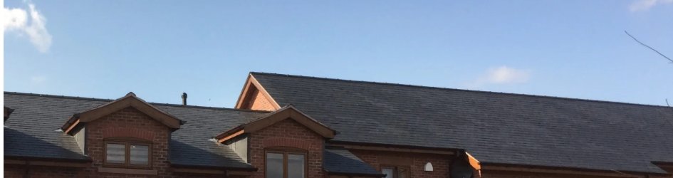 Neat slate roof with ridge and lead flashings on a Cheshire property