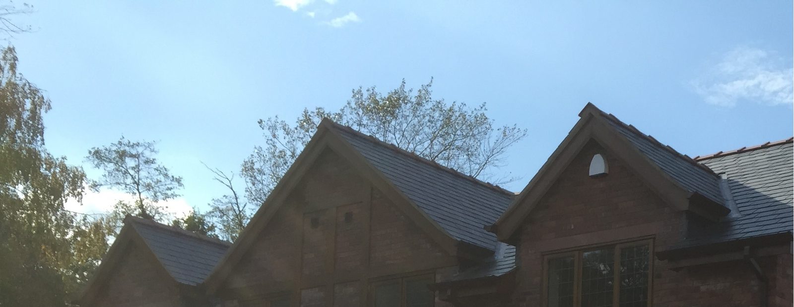 Natural slate roof with neat ridgeline and lead flashings